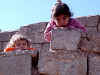 Iraq 2 kids on wall.jpg (87689 bytes)